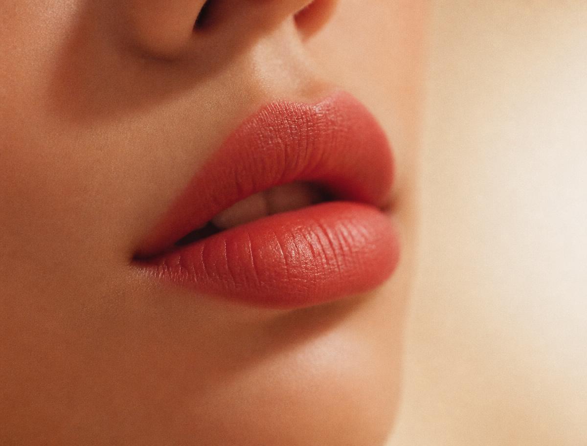 Close-up of lips wearing a warm red Kloset Kiss shade